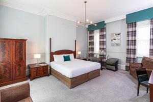 a bedroom with a bed and a living room at The Craiglands Hotel Sure Hotel Collection by Best Western in Ilkley
