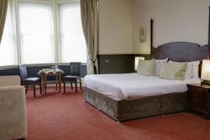 a bedroom with a large bed and a table at The Craiglands Hotel Sure Hotel Collection by Best Western in Ilkley +37 photos