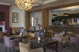 a restaurant with tables and chairs and a bar at The Craiglands Hotel Sure Hotel Collection by Best Western in Ilkley