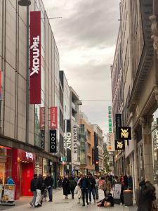 a group of people walking down a street in a city at The Crestline in Hannover