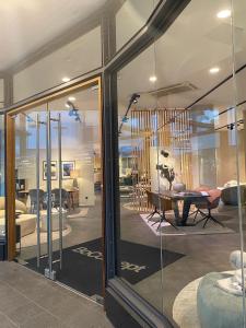 a room with glass doors and a room with a table at The Crestline in Hannover