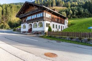 a large wooden house on the side of a road at A Nett’s Nest in Hainzenberg