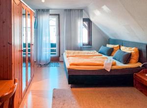 a bedroom with a large bed with blue pillows at Hotel Carlsruh in Braunlage