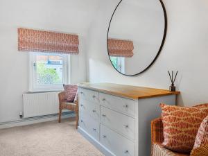 a dressing room with a mirror and a dresser at Warrington Mews-Uk48821 in Thornton Dale