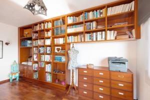 a room with wooden bookshelves and a dresser at Casa Marice in Premia de Dalt