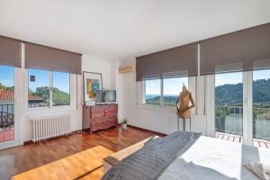 a bedroom with a bed and windows with a view at Casa Marice in Premia de Dalt +32 photos