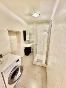 a bathroom with a washing machine and a shower at Next2Mozart-Apartment in Salzburg +39 photos