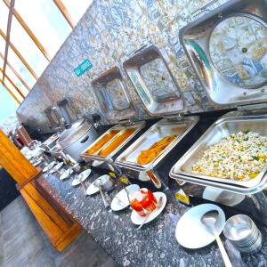 a buffet line with many different types of food at Resort Terra Paraiso Goa - A Beach Property in Calangute