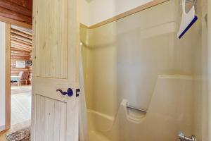 a bathroom with a white door and a toilet at Parker Lane Cabin in Weston +11 photos
