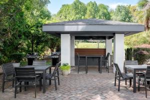 a pavilion with tables and chairs on a patio at Candlewood Suites Mooresville Lake Norman,NC by IHG in Mooresville