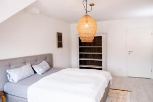 a bedroom with a bed and a pendant light at Appartement Seeblick in Lindau
