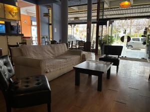 a living room with a couch and a table and chairs at Plaza Hotel Fray Bentos in Fray Bentos