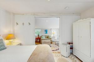 a bedroom with a bed and a living room at Heart of Edgartown in Edgartown