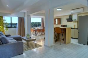 a living room and kitchen with a couch and a table at ZEN HOTEL, Nosy Be in Hell-Ville