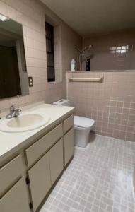 a bathroom with a sink and a toilet at Happy Vacation in Largo