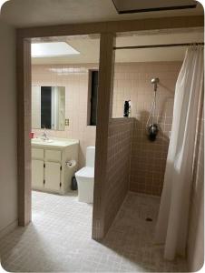 a bathroom with a shower and a toilet and a sink at Happy Vacation in Largo