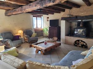 a living room with a couch and a coffee table at Le Séchoir D'Alice in Mauriac