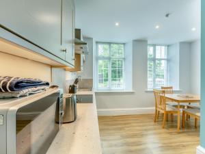a kitchen with a table and a dining room at Arnside Apartment in Lindale