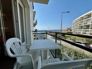 a white table and chairs on a balcony with a view at Quiberon - 2 pièces, 40m², 4 pers, parking, balcons, près de la mer - FR-1-478-26 in Quiberon