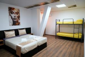 a room with a bed and two bunk beds at Hostel Tsanovi in Pleven +17 photos
