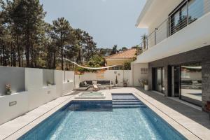 a swimming pool in the backyard of a house at Paraty Villa in Aroeira