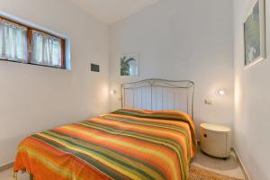 Ένα ή περισσότερα κρεβάτια σε δωμάτιο στο Terrazza Sulla Baia Marina di Campo