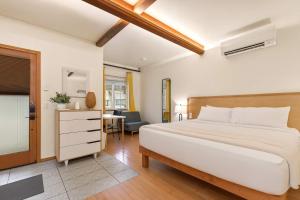 a bedroom with a large white bed and a desk at Snowcreek Suite - Cedar - ADA- Hot Tub - Kitchenette in Leavenworth