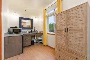 a kitchen with a counter with a microwave and a window at Snowcreek Suite - Cedar - ADA- Hot Tub - Kitchenette in Leavenworth