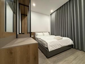 a small bedroom with a bed and a sink at Town House for rent in Thủ Đức in Ho Chi Minh City