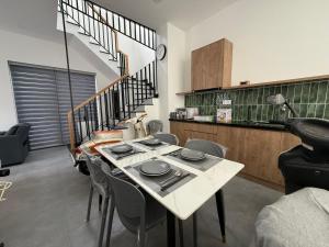 a dining room with a table with plates on it at Town House for rent in Thủ Đức in Ho Chi Minh City
