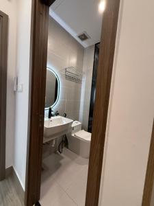 a bathroom with a sink and a toilet and a mirror at Town House for rent in Thủ Đức in Ho Chi Minh City +16 photos