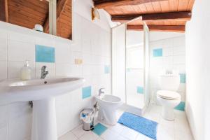 a bathroom with a sink and a toilet at Vista Alcantara Mountain Wellness in Motta Camastra +36 photos
