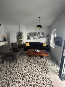 a living room with a couch and a coffee table at Casa Típica con Terraza in Ayamonte