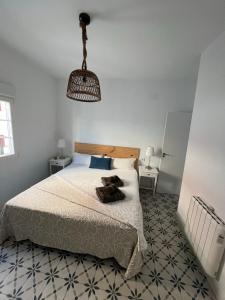 a bedroom with a bed with a teddy bear on it at Casa Típica con Terraza in Ayamonte +21 photos