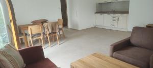 a living room with a couch and a table and chairs at Haus Einhorn in Nenningen