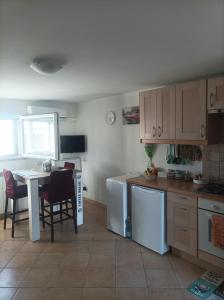 a kitchen with a table and a table and chairs at Casina sulla Sabbia in Torvaianica +42 photos