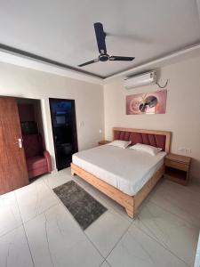 a bedroom with a bed and a ceiling fan at Joshi Homestay in Dehradun