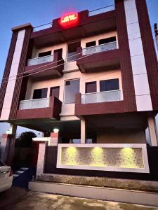 a building with a sign on the side of it at Joshi Homestay in Dehradun