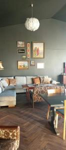 a living room with a couch and a table at Renovated Chapel With Fjord Views In Vågstranda in Reistad