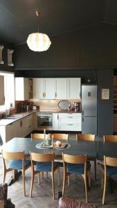 a kitchen with a table and chairs in a kitchen at Renovated Chapel With Fjord Views In Vågstranda in Reistad