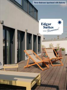 two lounge chairs on a deck next to a building at Edgar Suites Hameau - Porte de Versailles in Paris