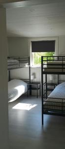 a bedroom with two bunk beds and a window at Renovated Chapel With Fjord Views In Vågstranda in Reistad