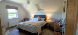 a small bedroom with a bed and a window at Gateside Lodge in Portrush