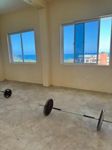 a empty room with two weights in a room with windows at Shuja Ranches in Kilifi