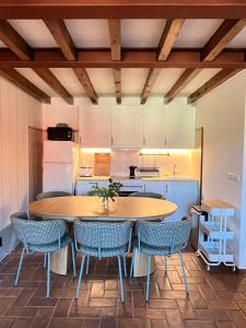 a kitchen with a large wooden table and chairs at Villa Dorotea - Casa Rural Vallines in Vallines
