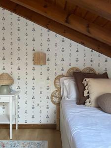 a bedroom with a bed and a wall at Villa Dorotea - Casa Rural Vallines in Vallines +17 photos
