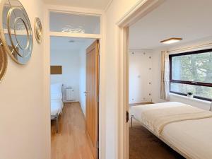 a small bedroom with a bed and a window at Russet Grove in Earlham