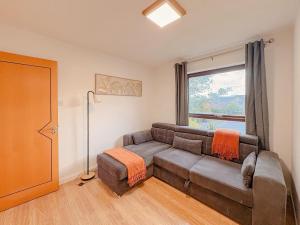 a living room with a couch and a window at Russet Grove in Earlham