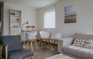 a living room with a couch and chairs and a table at Westergeest Luxe in Uitgeest