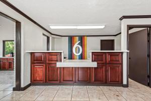 a large room with wooden doors and a sink at Studio 6 Hammond, LA I12 I55 in Hammond
